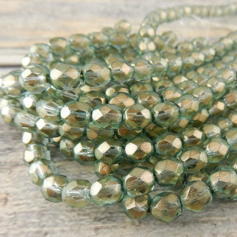 HALO HEAVENS 6mm Faceted Round Czech Glass Beads Qty 25 Fire Polished, Gorgeous Light Green with Metallic Gold Finish