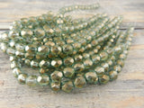 HALO HEAVENS 6mm Faceted Round Czech Glass Beads Qty 25 Fire Polished, Gorgeous Light Green with Metallic Gold Finish